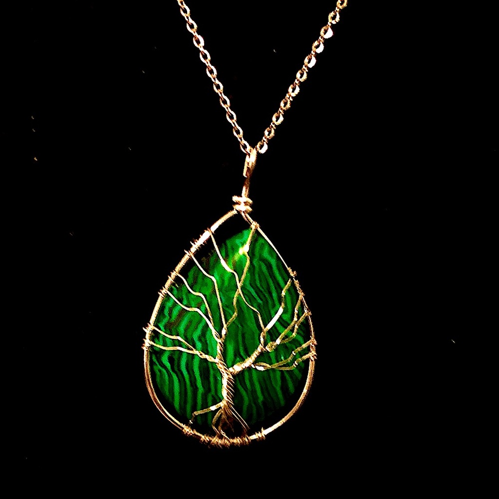 Malachite wrapped w/silver wire on a silver chain. Pendant is approximately 2.25